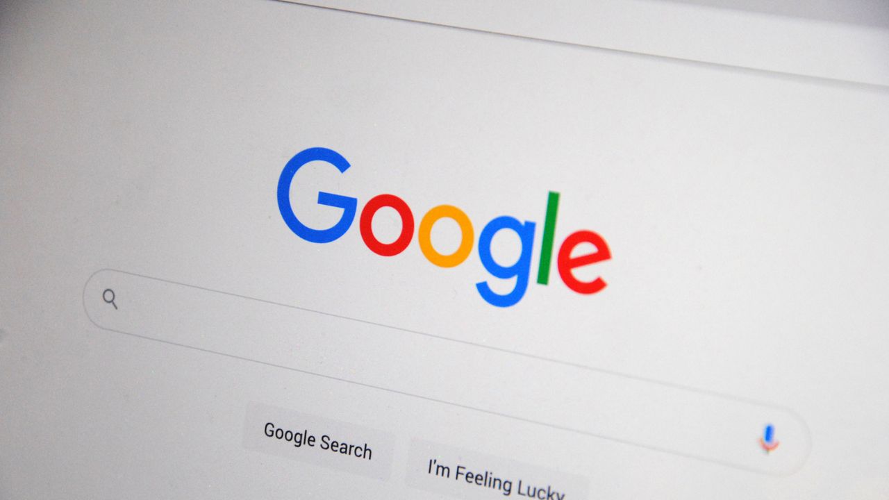 Close-up of the Google homepage on a screen showing search options.