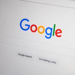 Close-up of the Google homepage on a screen showing search options.