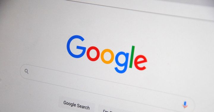 Close-up of the Google homepage on a screen showing search options.